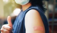 Band-aid on arm after a vaccine.