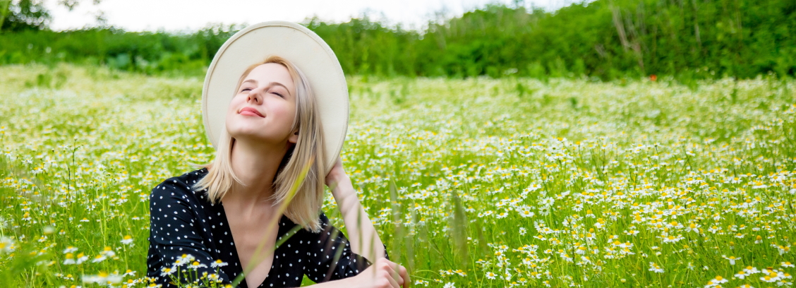 Happy woman enjoying allergy free time in field